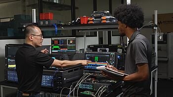Engineers using oscilloscope.