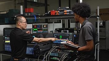 Engineers using an oscilloscope